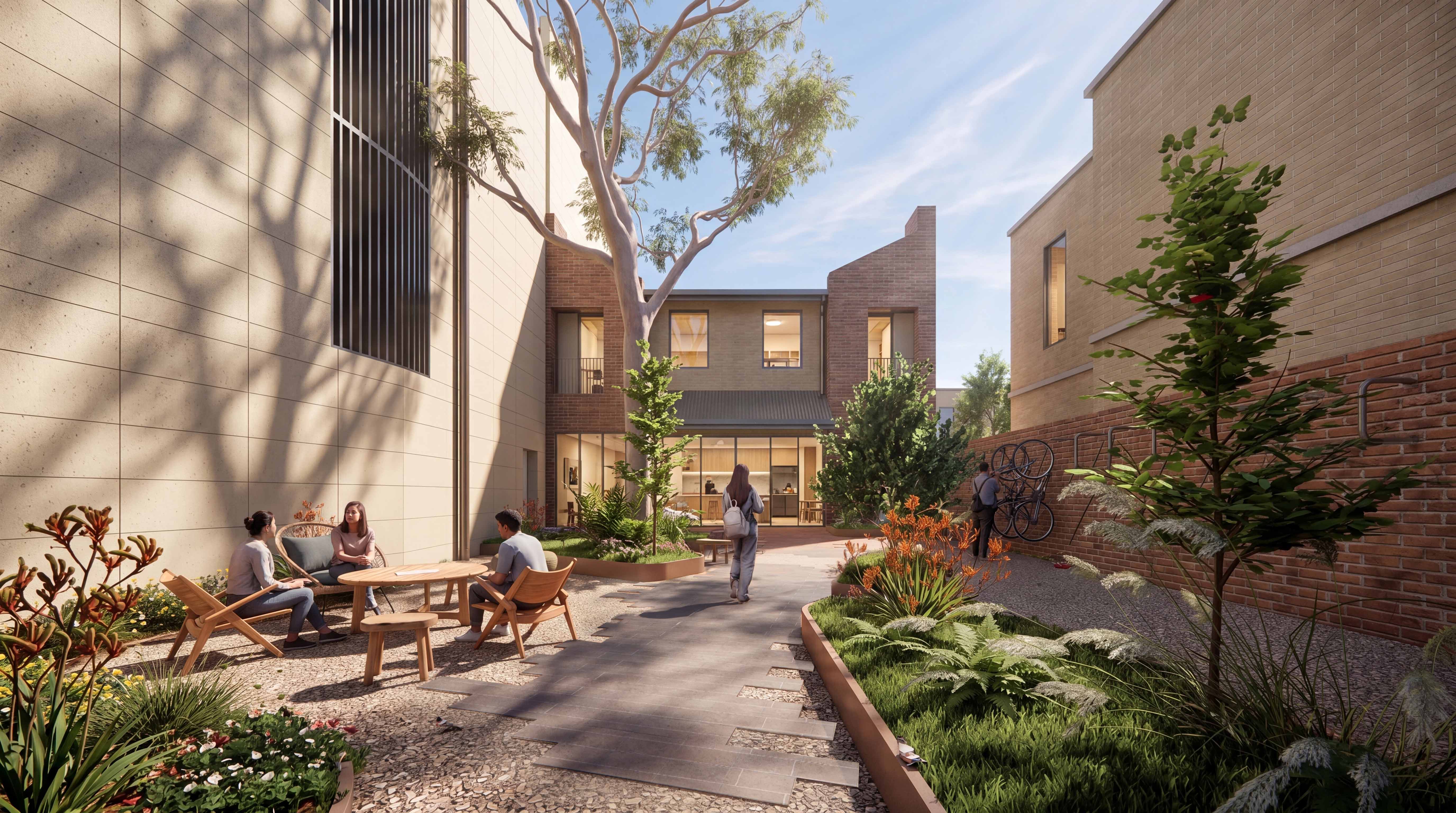 Residents chatting and walking through a landscaped courtyard with native planting and bike storage at The Arundel.